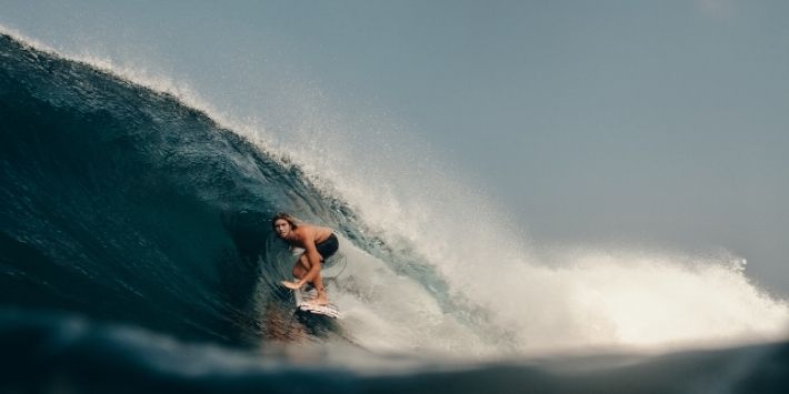 A child surfing gracefully on the waves of Mentawai Island