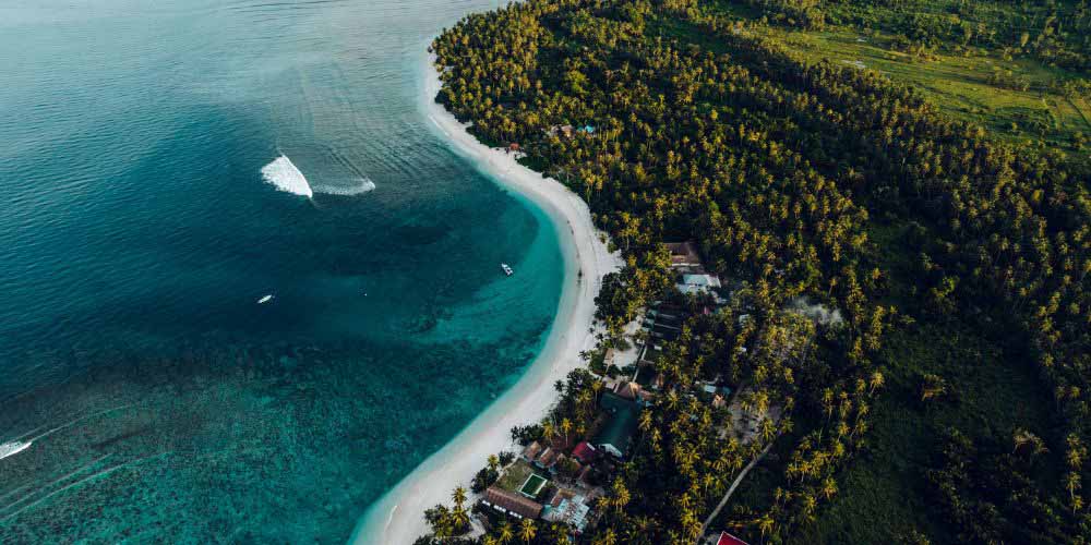 Why do waves break at the shoreline?