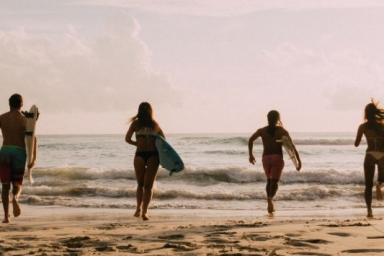Teens bonding over surfing, enjoying waves, and exploring together